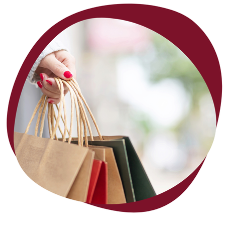 person holding a bunch of shopping bags from retail stores